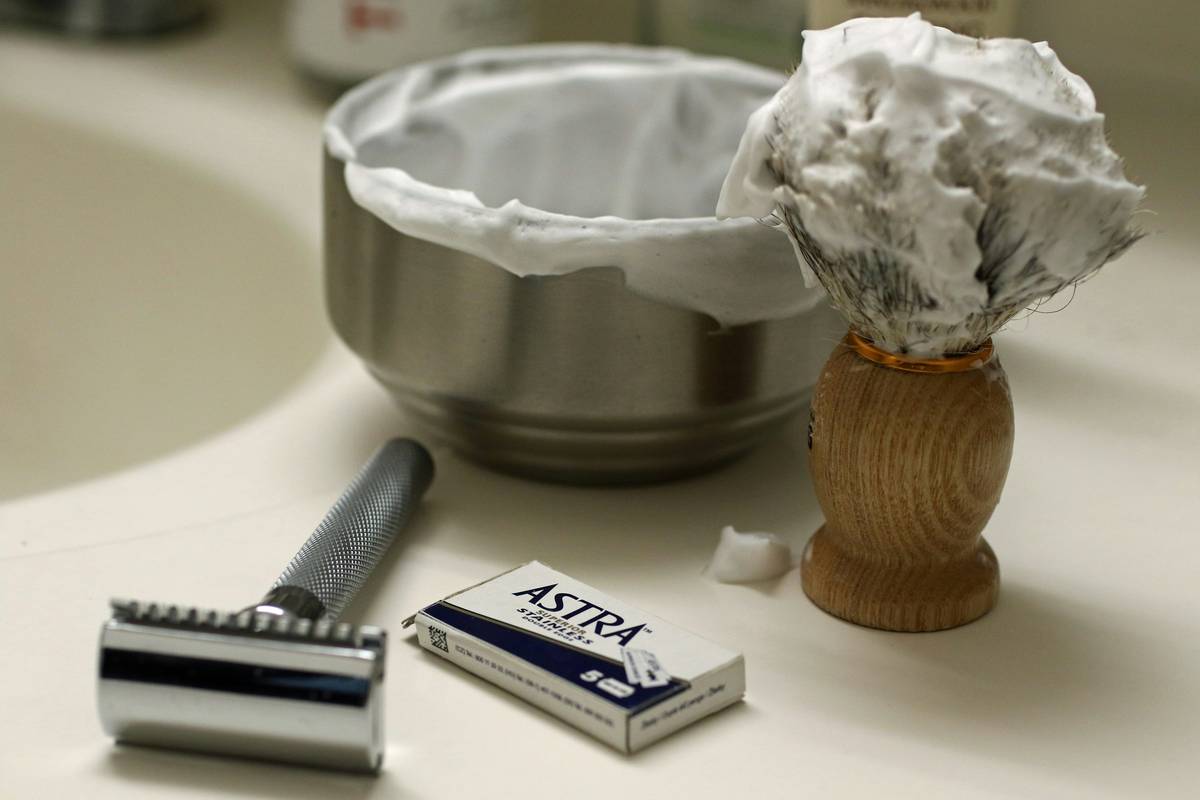 Close-up of creamy lather from a shaving soap for irritation reduction applied to beard area with badger brush
