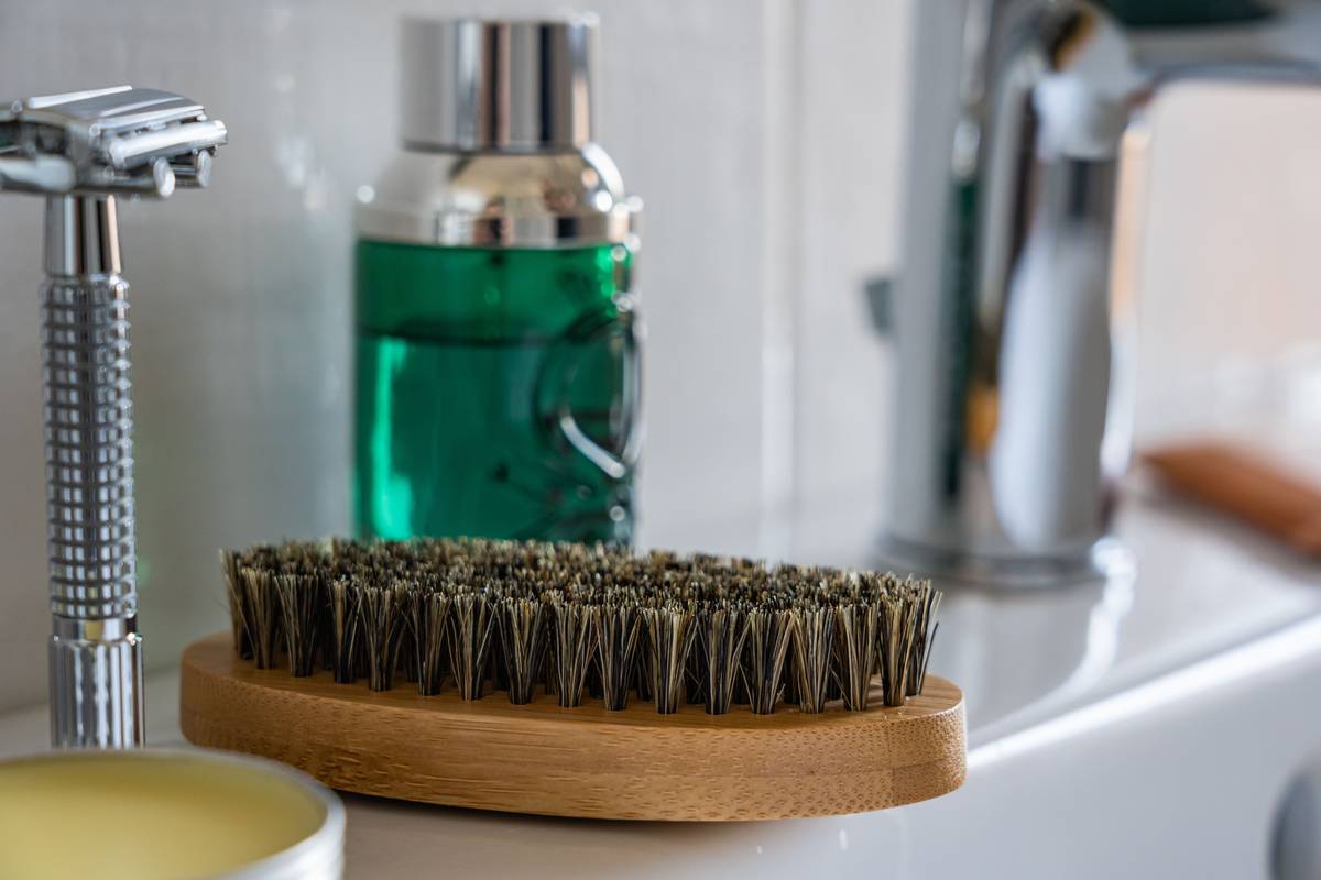 grooming supplies for beard maintenance including artisanal shaving soap, badger brush, and ceramic bowl